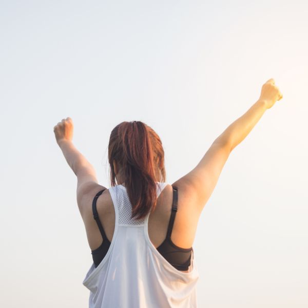 Woman raising her arms to celebrate